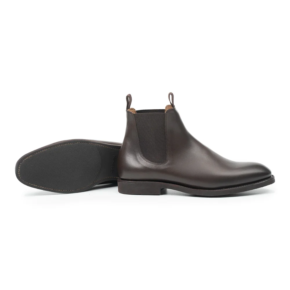 Brown leather Chelsea boots with elastic side panels and pull tabs.