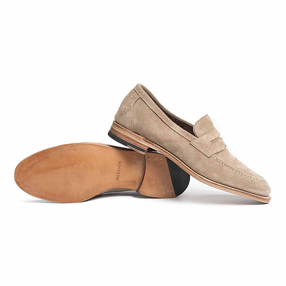 Beige suede loafers with a leather sole.