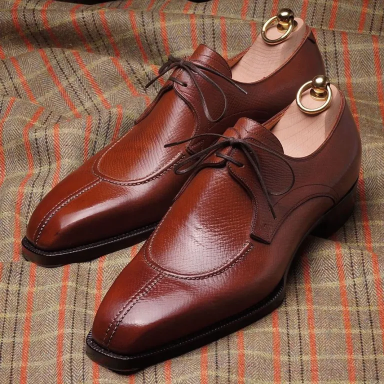Brown leather dress shoes with a sleek design and lace-up closure.