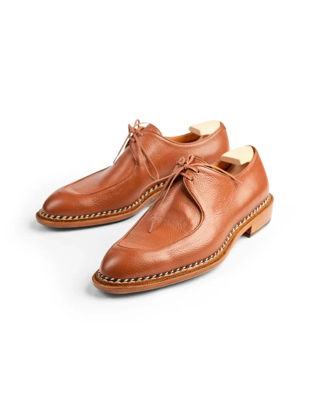 A pair of brown leather dress shoes with a sleek design and lace-up closure.