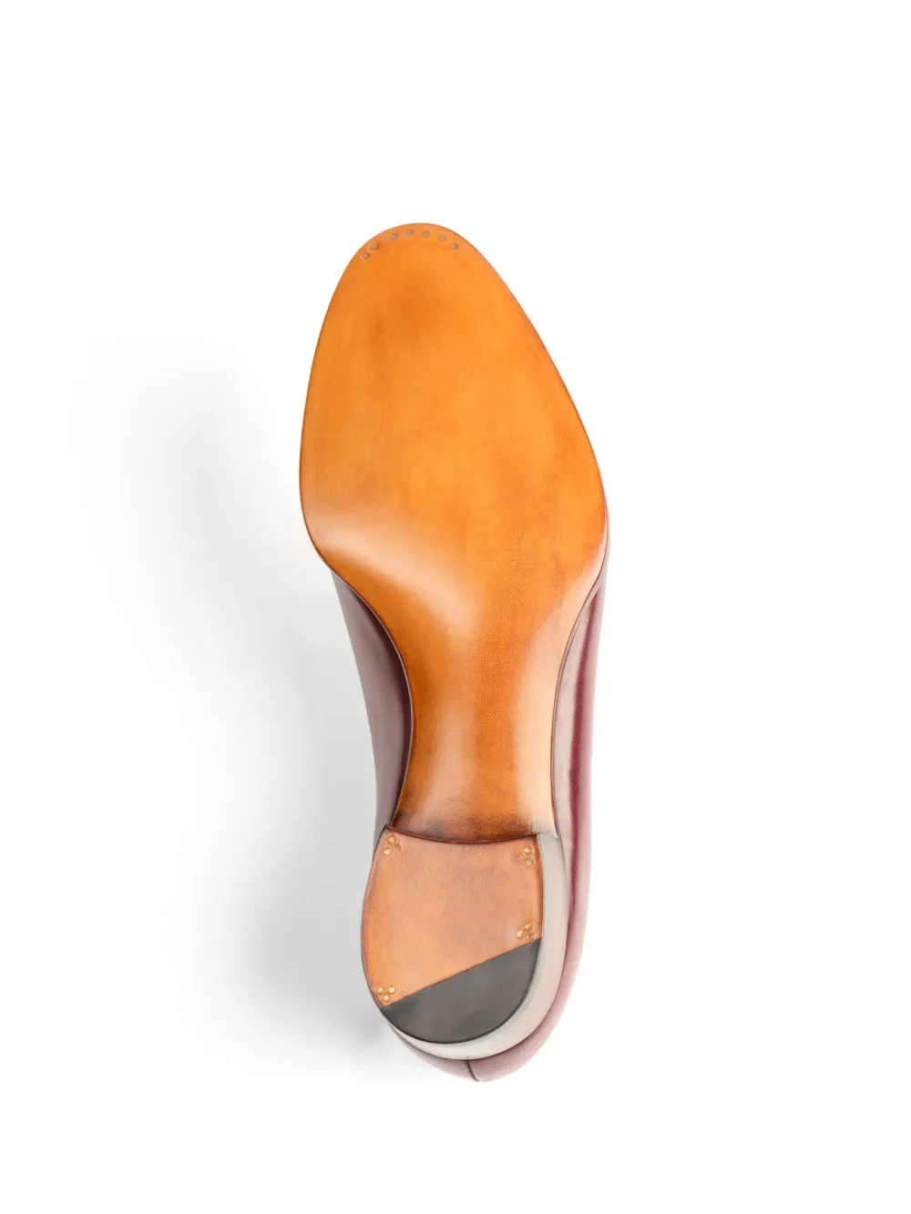 The image shows the bottom of a shoe with a tan leather sole and a dark burgundy upper.