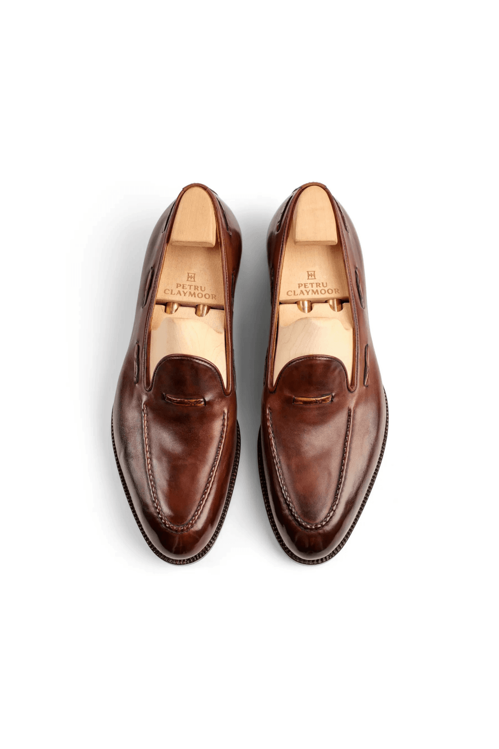 Brown leather loafers with a sleek design and visible stitching.