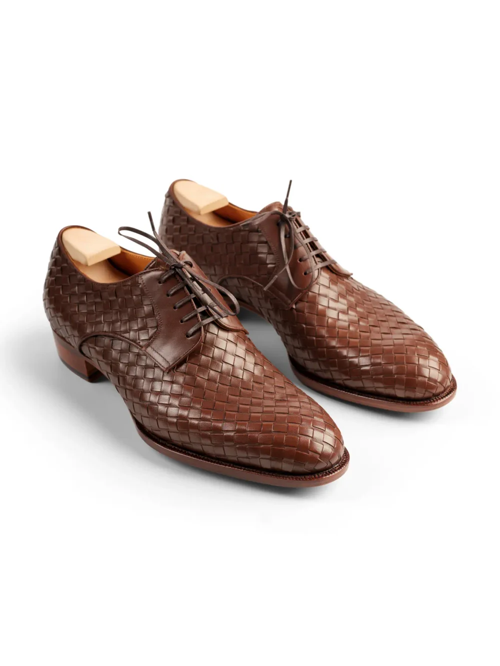 Brown woven leather dress shoes with laces.