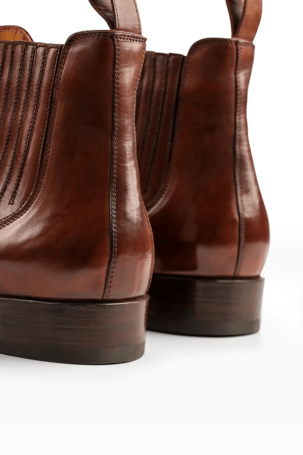 Brown leather ankle boots with a smooth finish and a stacked wooden heel.