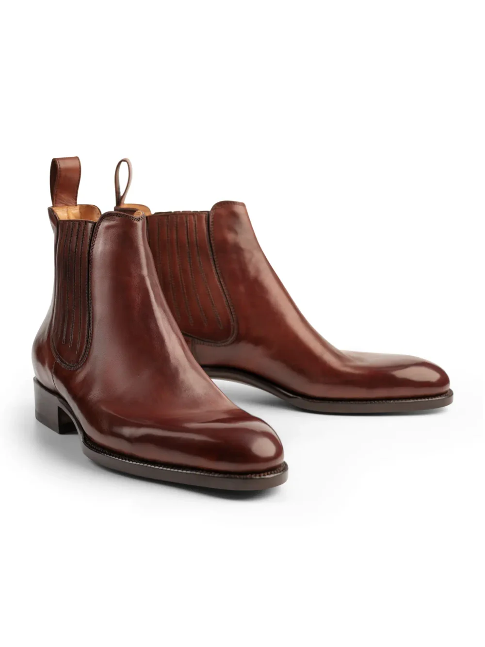 A pair of polished burgundy leather Chelsea boots with elastic side panels and pull tabs.