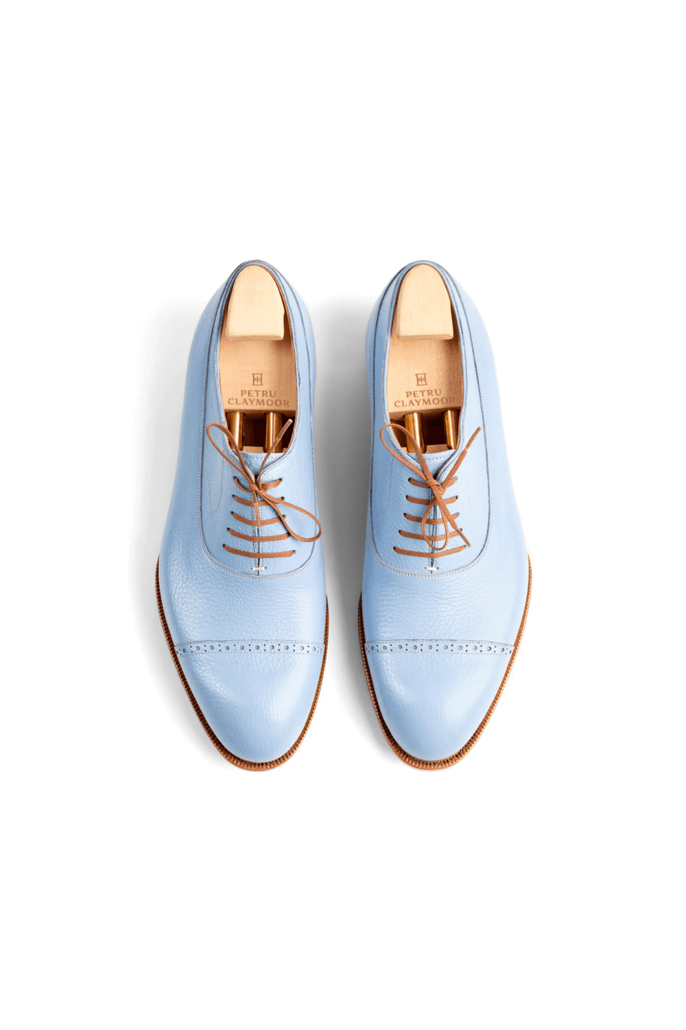Light blue leather dress shoes with brown laces and a smooth finish.