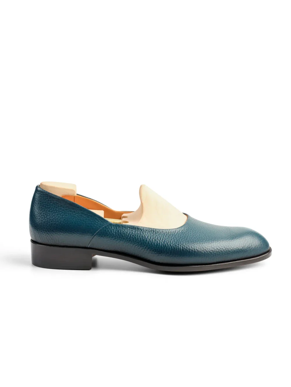 Teal leather shoe with a low heel and cut-out design.