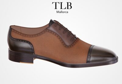 Brown leather dress shoe with a dark brown cap toe and decorative stitching.